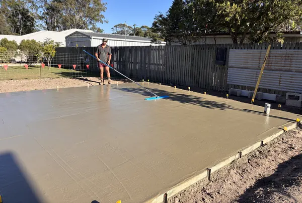Jesse screeding a freshly poured concrete slab